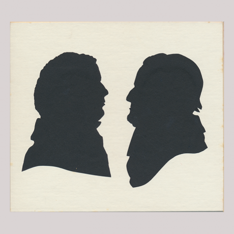 
        Front of silhouette, with two men. The man on the left is looking right; the man on the right is looking left and is wearing a hat.